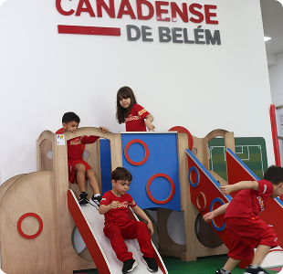 Crianças brincando em playground indoor de madeira da Canadian Global School